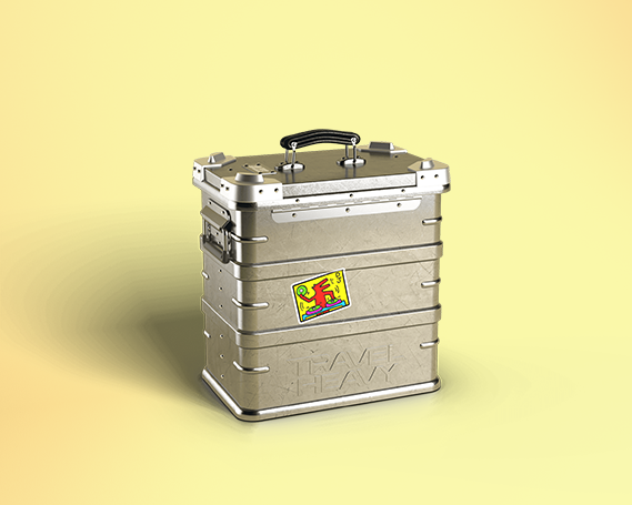 Closed Travel Heavy aluminium record case with the embossed Travel Heavy logo and a colourful sticker